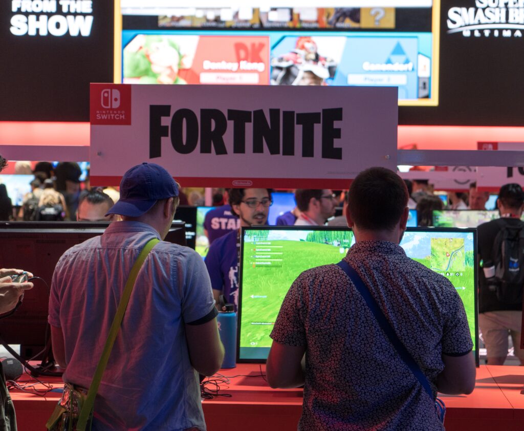 Sergey Galyonkin from Raleigh, USA, People playing Fortnite at E3 2018, CC BY-SA 2.0